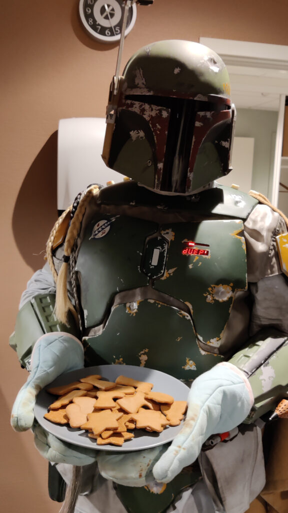 Boba Fett holds up a plate of gingerbread cookies.