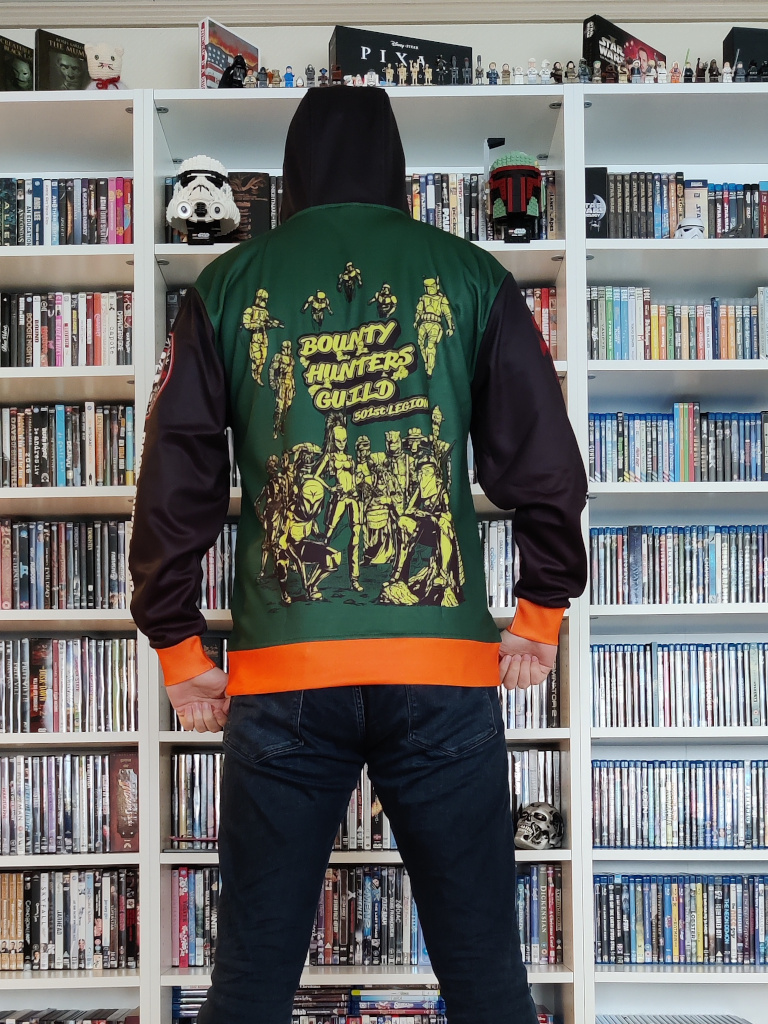 A picture of me wearing the jacket. We see me from behind, hoodie up. The backside of the jacket features Boba, Jango, Aurra Sing, Din Jarin, Bo-Katan and several other bounty hunters and Mandalorians.