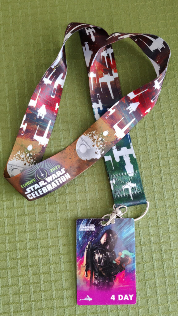 A lanyard with the Star Wars Celebration Europe 2023 artwork and colors and the 4 day badge.