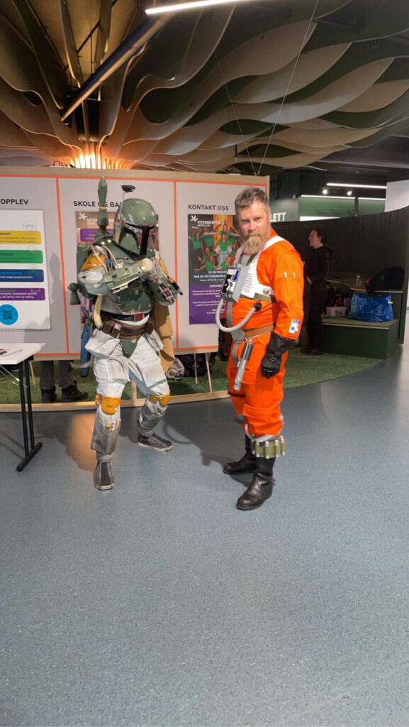 Boba Fett and an X-Wing pilot posing for the camera.
