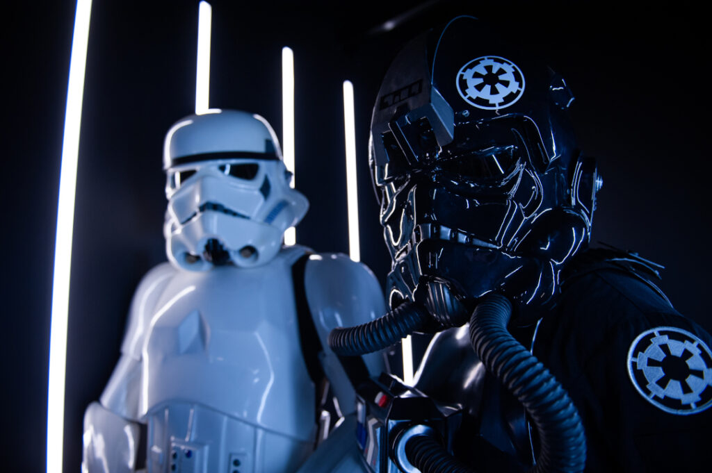 A stormtrooper and TIE pilot looking at the camera with confidence.
