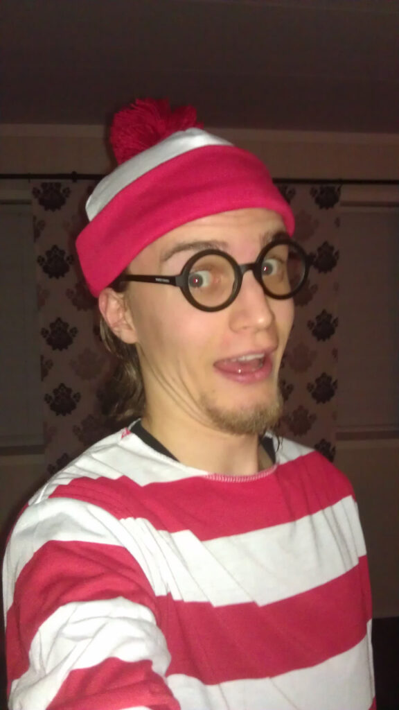 Me in a Waldo costume. It's a white and red striped shirt, a red and white hat, and a pair of round, wide rimmed glasses