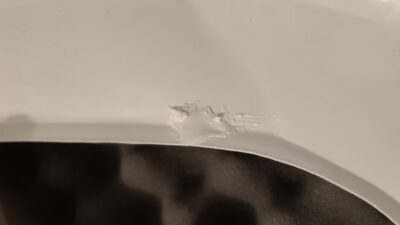 A close-up of a piece of stormtrooper armor with ABS paste. The crack is no longer there. But the paste is a blob and weirdly shaped.