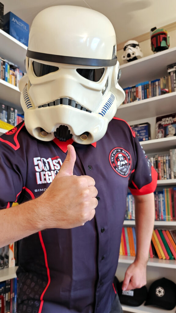 I am wearing the shirt and my stormtrooper helmet. I'm facing the camera, giving a thumbs-up.