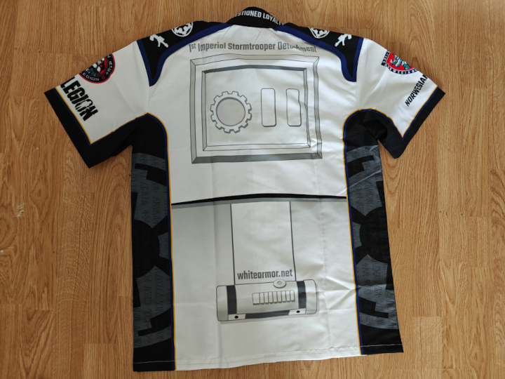 A white club shirt, seen from the back. It lays flat on the floor.The back is decorated with details found in the stormtrooper armor.