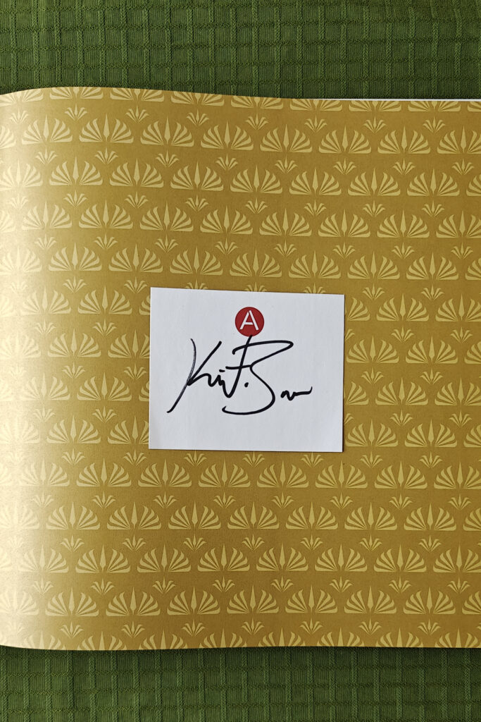 Baver's signature on a white note inside the book.