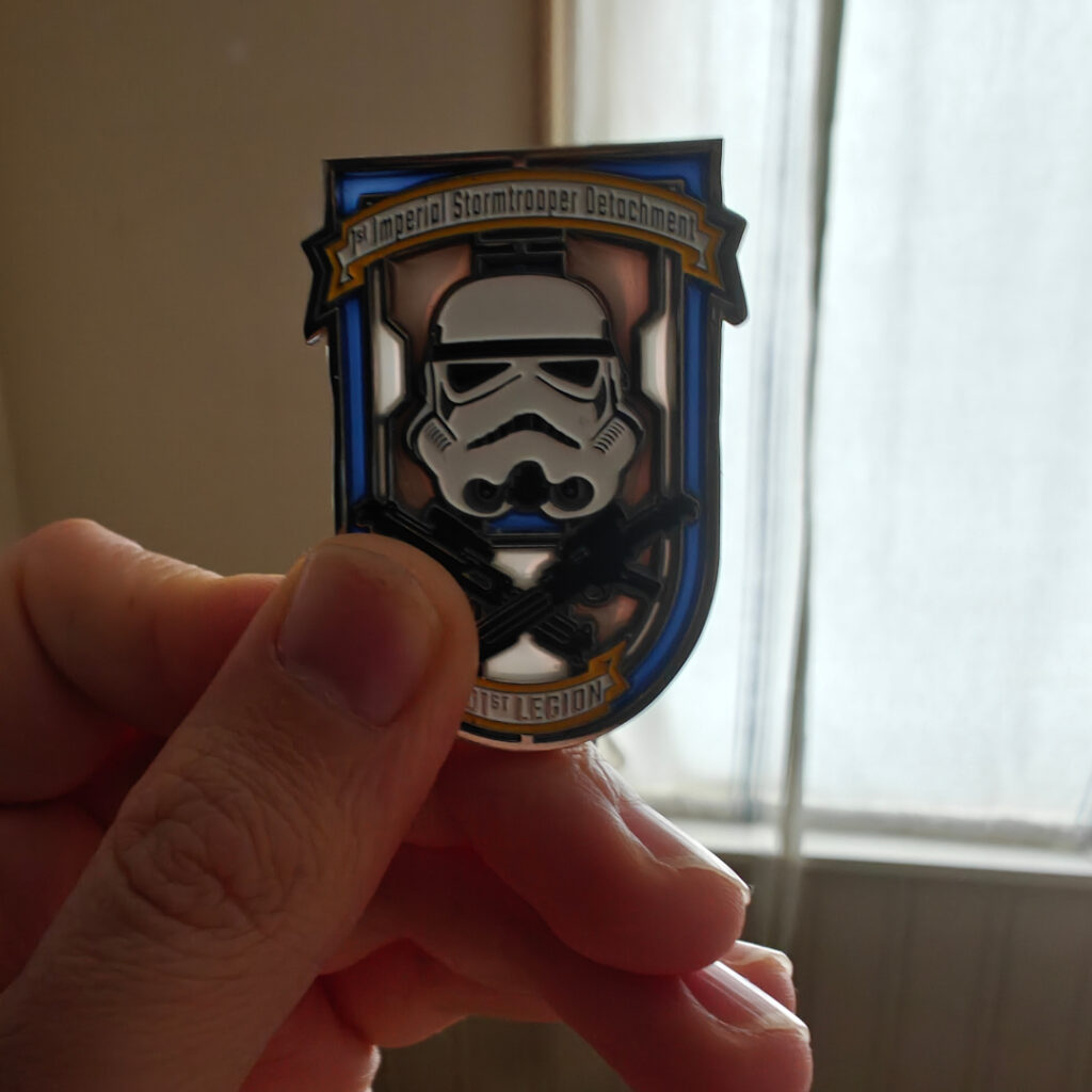 The coin is held up to the light. We see that the white and blue background is translucent glass.