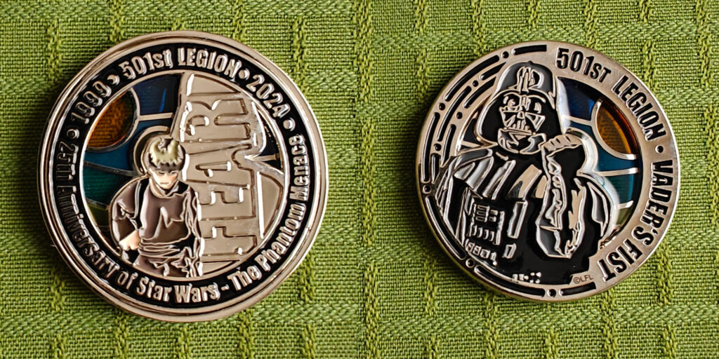 The coin seen from both sides. The front features Anakin Skywalker as a boy. Behind him is the word "FEAR". The border of the coin reads "1999. 501st Legion. 2024. 25th Anniversary of Star Wars - The Phantom Menace". The back feaures Darth Vader shaking his fist menacingly. The border of the coin reads "501st Legion - Vader's Fist".