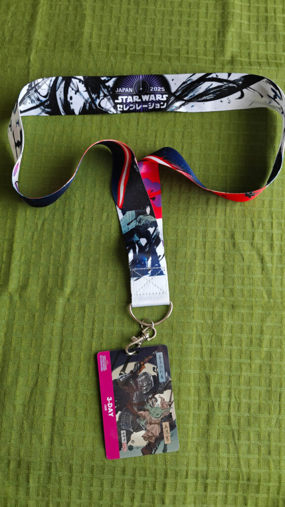 A lanyard with artwork and a 3-day pass.