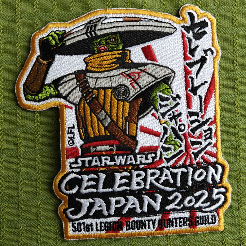 An embroidered patch featuring Embo, a Kyuzo bounty hunter with a large hat and samurai inspiried armor. The background is white with red stripes, like a rising sun. Text: "Star Wars Celebration Japan 2025. 501st Legion Bounty Hunters Guild". There's also some signs I'm unable to decifer.