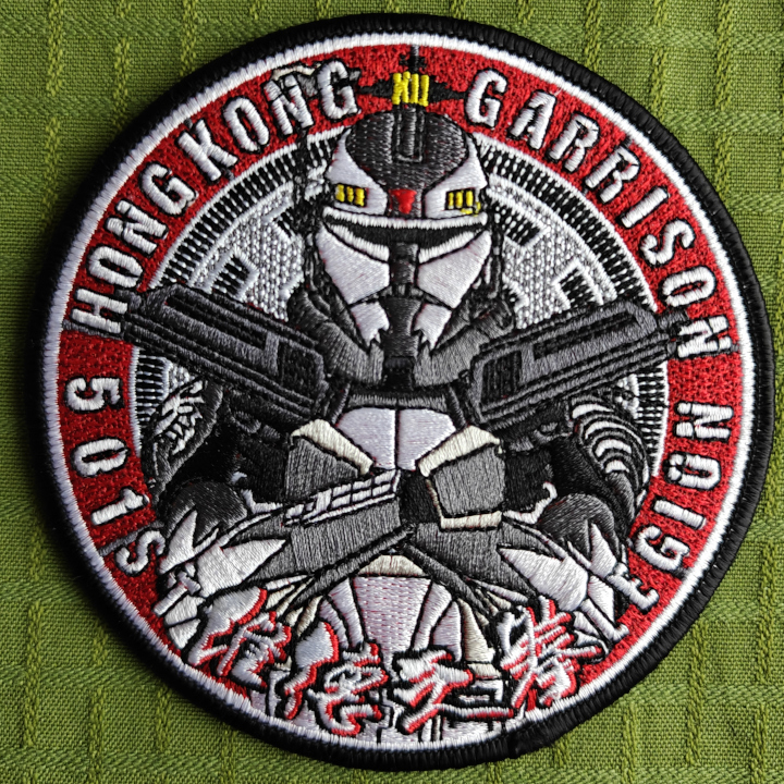 An embroidered patch featuring a trooper with two blasters in a cross. Text: 501st Legion Hong Kong Garrison