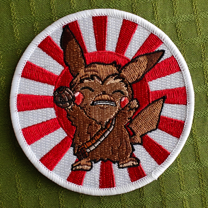 An embroidered patch with a Pikachu + Chewbacca mashup. Behind the figure is a red and white japanese sun.